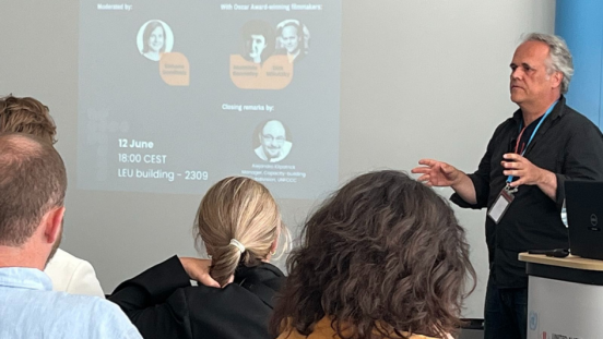 Academy Award-winning director Dirk Wilutzky giving a talk in front of an audience